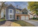 Charming two-story home with a well-manicured lawn and attached two-car garage at 4975 Skyland Pkwy, Cumming, GA 30028