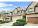 Charming two-story townhome with a well-manicured front yard and attached garage at 5669 Cobblestone Creek Pl # 12, Mableton, GA 30126