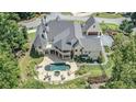 Expansive property featuring a luxurious pool area, landscaped grounds, and a beautifully designed home at 211 Meritage Dr, Alpharetta, GA 30022