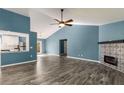 Spacious living room featuring a decorative fireplace, vaulted ceiling, and access to the modern kitchen at 309 Elizabeth Blvd, Alpharetta, GA 30009