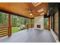 Relax on the covered porch, featuring a ceiling fan, skylights, and a wood-burning fireplace at 3356 Thornewood Dr, Atlanta, GA 30340