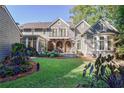 Beautiful backyard featuring a well-manicured lawn, elegant landscaping, and a serene outdoor space at 1691 Doncaster Ne Dr, Atlanta, GA 30309