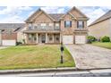 Charming two-story brick home featuring a well-maintained front yard and a two-car garage at 80 Lanier Rdg, Acworth, GA 30101