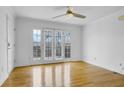 Bright living room features hardwood floors, ceiling fan, and French doors to the balcony at 869 Briarcliff Ne Rd # B11, Atlanta, GA 30306
