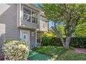 Inviting townhome with neat lawn, blossoming bush, and secure ADT system at 105 Governors Dr, Forest Park, GA 30297