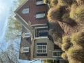 Charming two-story home with a combination of brick and siding, complemented by well-maintained landscaping at 1081 Bridgemill Ave, Canton, GA 30114