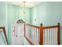 Bright entryway featuring a charming staircase with a white railing and a light fixture at 1019 James Madison Ct, Mcdonough, GA 30253