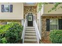 Welcoming front entrance with stone accents and a decorative wreath on the black front door at 1019 James Madison Ct, Mcdonough, GA 30253