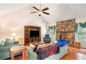 Inviting living room with stone fireplace, vaulted ceilings, and natural light from large windows at 1019 James Madison Ct, Mcdonough, GA 30253