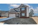 Attractive two-story home boasts brick accents, a spacious two-car garage, and a meticulously maintained yard at 412 Westmarch Cir, Loganville, GA 30052