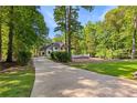 Driveway leading up to the property showcases lush landscaping, mature trees, and privacy at 450 Birkdale Dr, Fayetteville, GA 30215
