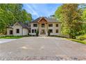 The two-story home has manicured lawns, beautiful window shutters, and a spacious driveway at 450 Birkdale Dr, Fayetteville, GA 30215