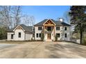 Elegant two-story home featuring a light brick facade, a symmetrical design, and a spacious front yard at 450 Birkdale Dr, Fayetteville, GA 30215