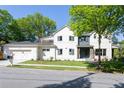 Handsome two-story home with a two-car garage and a white painted brick exterior at 48 25Th St, Atlanta, GA 30309