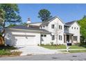 Lovely two-story home with a two-car garage and a white painted brick exterior at 48 25Th St, Atlanta, GA 30309