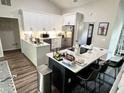 Open-concept kitchen with central island, modern appliances, and stylish countertops at 6060 Carriage Dr, Cumming, GA 30028
