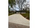 Long driveway leading to a charming home with well maintained lawn and mature trees at 4321 Austell Powder Springs Sw Rd, Powder Springs, GA 30127