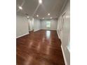 Bright and spacious living room with hardwood floors and a large window overlooking the yard at 4321 Austell Powder Springs Sw Rd, Powder Springs, GA 30127