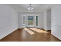 Bright dining room with hardwood floors and a sunlit bay window at 9415 Martin Rd, Roswell, GA 30076