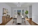 Elegant dining room featuring modern lighting, large bay window and stylish furnishings at 9415 Martin Rd, Roswell, GA 30076