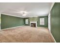 Spacious living room with fireplace, large windows, and neutral carpeting at 2330 Burlington Ln, Snellville, GA 30078