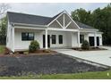 Beautiful one-story home with white siding, black trim, and well-manicured landscaping at 4824 Highway 20 Se, Conyers, GA 30013