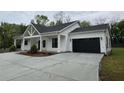 Charming one-story home with a black garage door, white siding and a large driveway at 4824 Highway 20 Se, Conyers, GA 30013