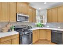 Kitchen featuring white countertops, stainless steel microwave, and black stove at 5450 Piney Grove Dr, Cumming, GA 30040