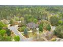 A stunning home with mature landscaping and a private, wooded setting at 800 Flathead Pass, Suwanee, GA 30024