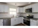 Bright kitchen featuring stainless steel appliances, granite countertops, white subway tile backsplash, and hardwood flooring at 4704 Apache Sw Trl, Atlanta, GA 30331