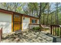 Inviting front porch with wood flooring and a decorative front door, offering a warm welcome at 4980 W Chapel Hill Rd, Douglasville, GA 30135