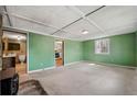 Bright living room with green walls, carpet flooring, and natural light, adjacent to kitchen and bathroom at 4980 W Chapel Hill Rd, Douglasville, GA 30135