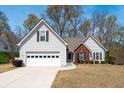 Charming two-story home with white siding, brick accents, attached garage, and a well-manicured front yard at 1545 Heatherton Rd, Dacula, GA 30019