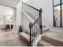 Bright entryway featuring an staircase with dark banister, bench seating, and views into the open concept living area at 2240 Arnold Mill Nw Rd, Lawrenceville, GA 30044