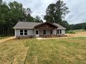 Charming home with gray siding, stone accents, and a cozy covered front porch at 482 West Ave, Bowdon, GA 30108