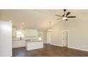 Bright living space with open floor plan, vaulted ceiling, and hardwood floors throughout at 482 West Ave, Bowdon, GA 30108
