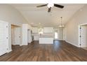 Open concept living space boasts wood floors and bright kitchen with island and stainless steel appliances at 482 West Ave, Bowdon, GA 30108
