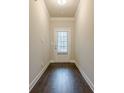 Hallway with a door and dark hardwood floors at 228 Dorothy Ln, Lawrenceville, GA 30046