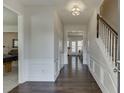 Inviting hallway with hardwood floors, white trim, and a staircase leading to the upper level at 230 Ascalon Ct, Johns Creek, GA 30005