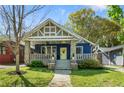 Inviting craftsman home with blue facade, stone porch columns, and mature landscaping at 1514 Rogers Sw Ave, Atlanta, GA 30310