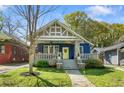 Attractive home with blue brick, stone porch columns, a yellow front door, and a manicured lawn at 1514 Rogers Sw Ave, Atlanta, GA 30310
