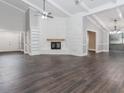 Spacious living room with vaulted ceilings, a stone fireplace, and wood floors, offering a bright and airy feel at 247 Old Timber Rd, Lawrenceville, GA 30046
