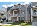 Beautiful two-story home with a covered porch, attached garages, and manicured landscaping at 319 Riverton Way, Woodstock, GA 30188