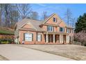 Beautiful brick home with mature trees, a manicured lawn, and a side-entry garage at 4710 Mcintosh Dr, Cumming, GA 30040