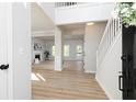 Bright, two-story foyer with hardwood floors leading to a living area and staircase at 55 Maple Leaf Ct, Dallas, GA 30157