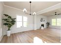 Spacious living room with a fireplace, natural light, and decorative wainscoting at 55 Maple Leaf Ct, Dallas, GA 30157
