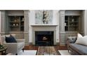 Elegant living room featuring a marble fireplace and custom built-in shelving at 4015 Brookhollow Dr, Douglasville, GA 30135