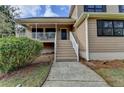 Front exterior showcasing covered porch with stairway and mature landscaping at 417 Wood Branch St, Woodstock, GA 30188