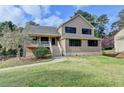 Inviting two-story home with a covered porch and mature landscaping at 417 Wood Branch St, Woodstock, GA 30188