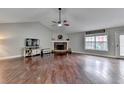 Bright living room with hardwood floors, stone fireplace, and TV console at 417 Wood Branch St, Woodstock, GA 30188